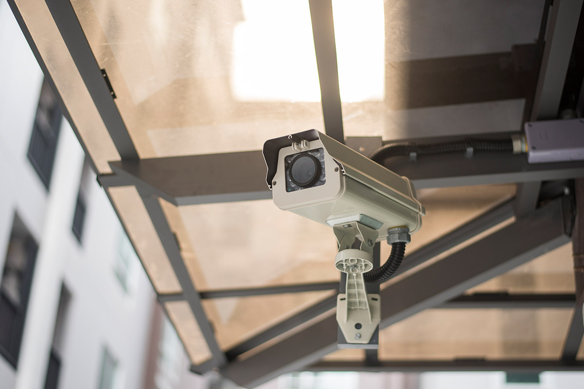 Ceiling-mounted security camera in a corridor (representative image)
