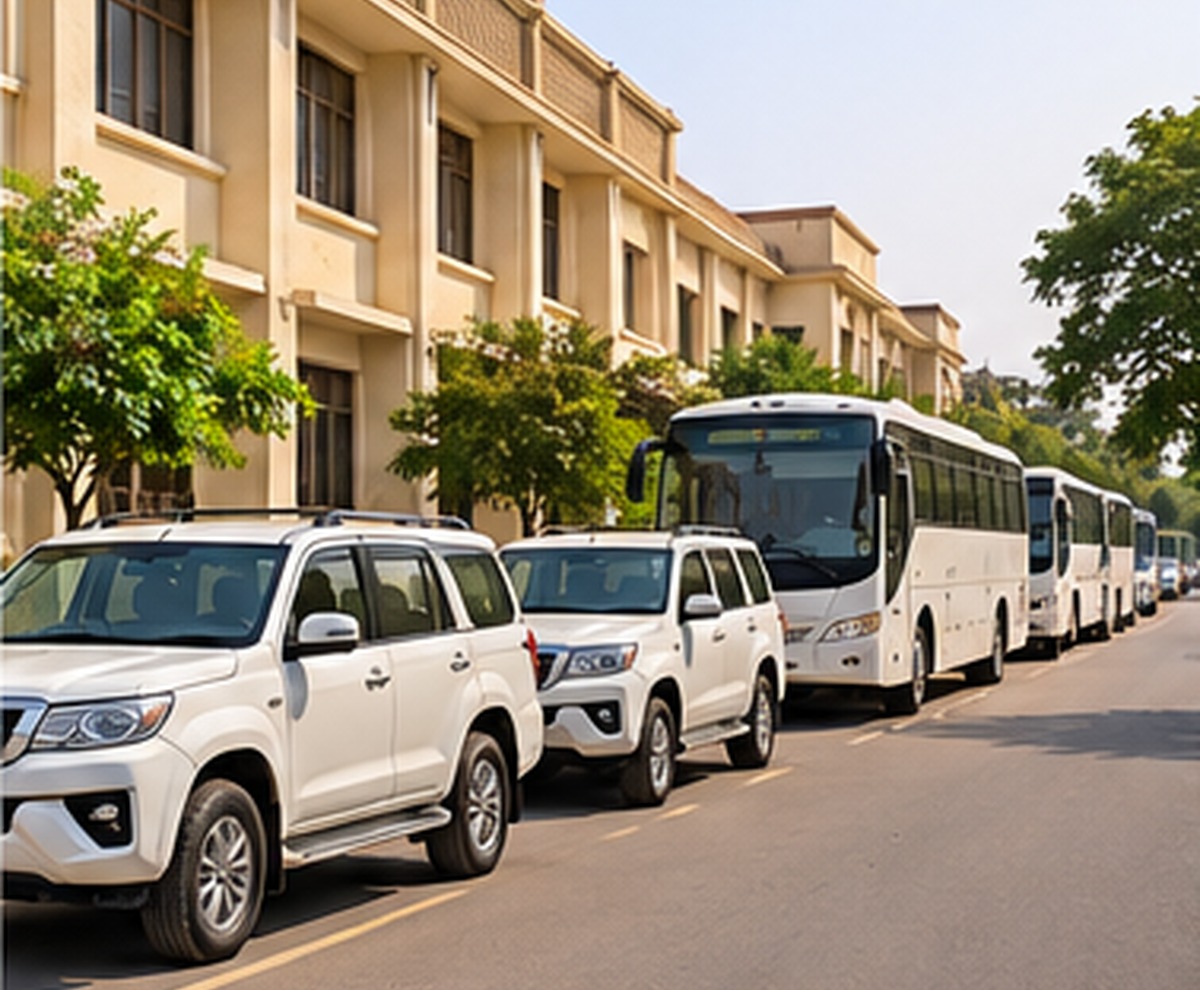 Representative fleet of white SUVs and buses outside an institutional building
